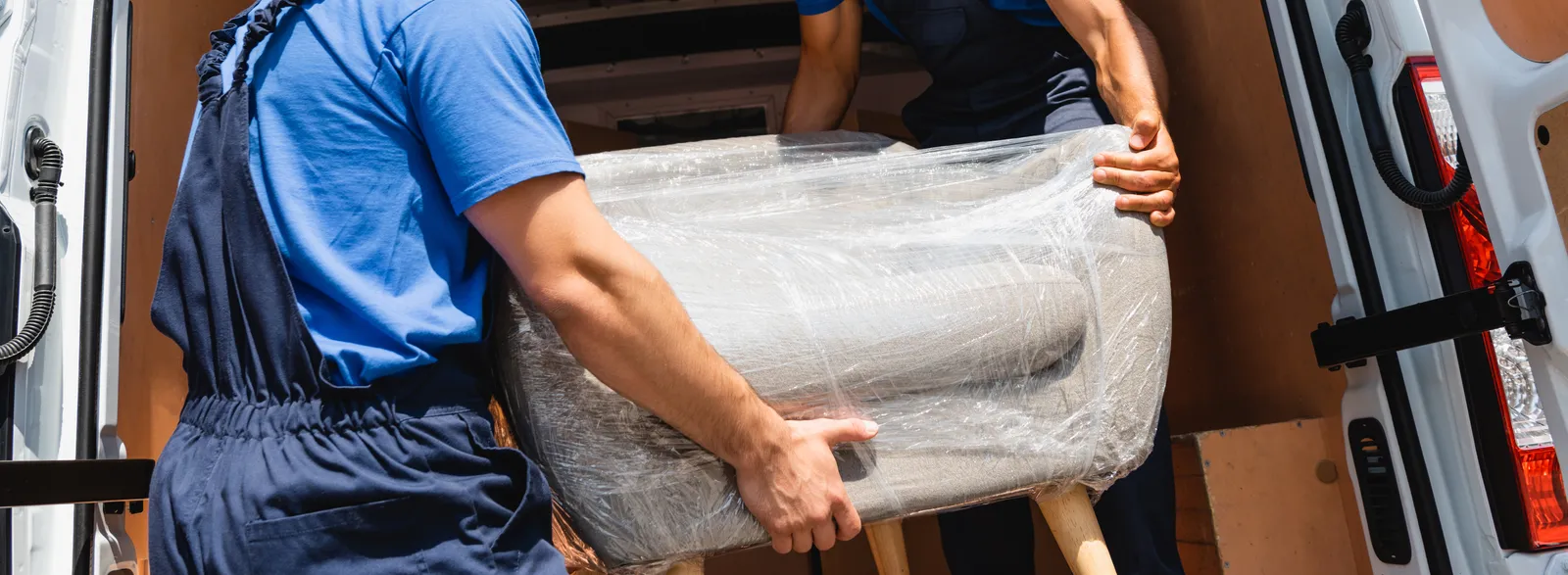 Two-person crew loading furniture into a moving van